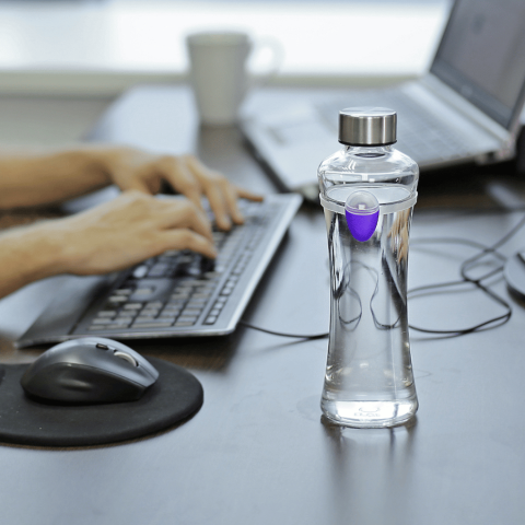 Ulla smart hydration reminder on desk with man working on computer